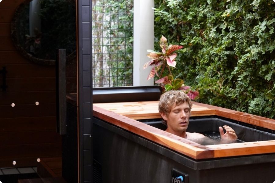 Person in renu therapy cold plunge with garden view