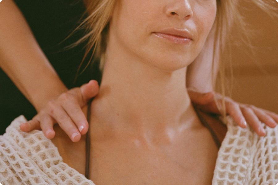 Close-up of a woman with a textured garment and blurred background